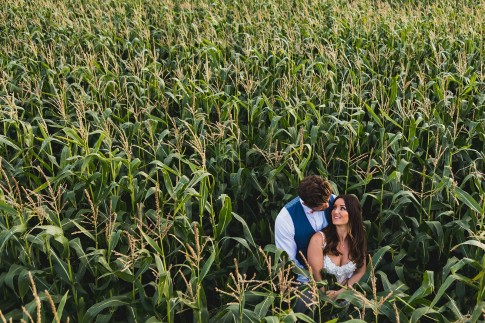 bride and groom in cornfield