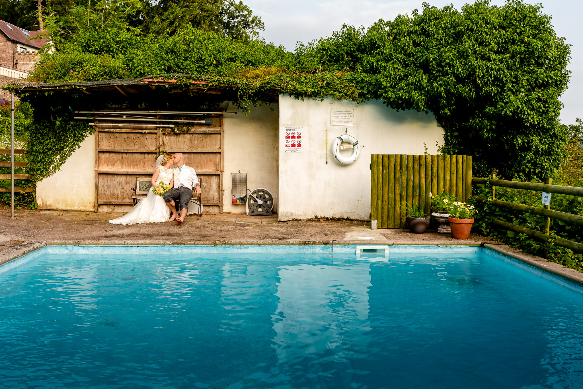 Art by Design - Caer Llan Wedding Photography - Bride and Groom by the pool