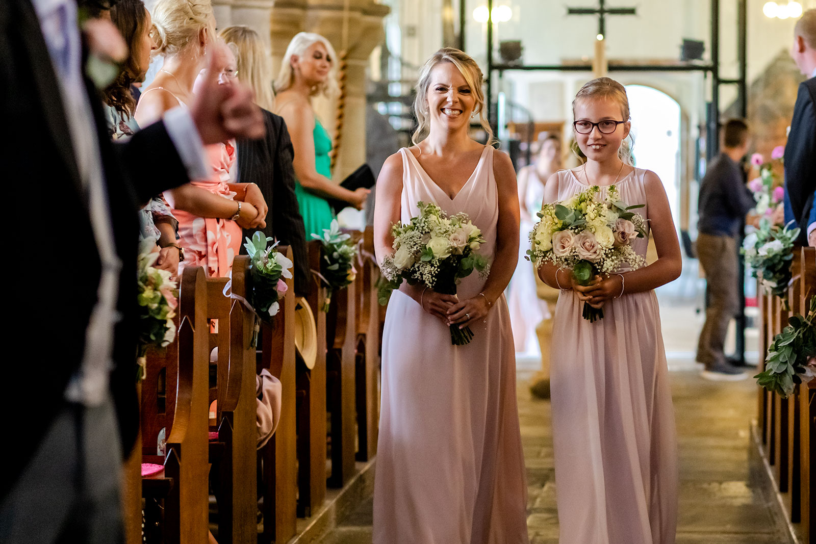 Bridesmaid enter St illtuds Church in Llantwit Major