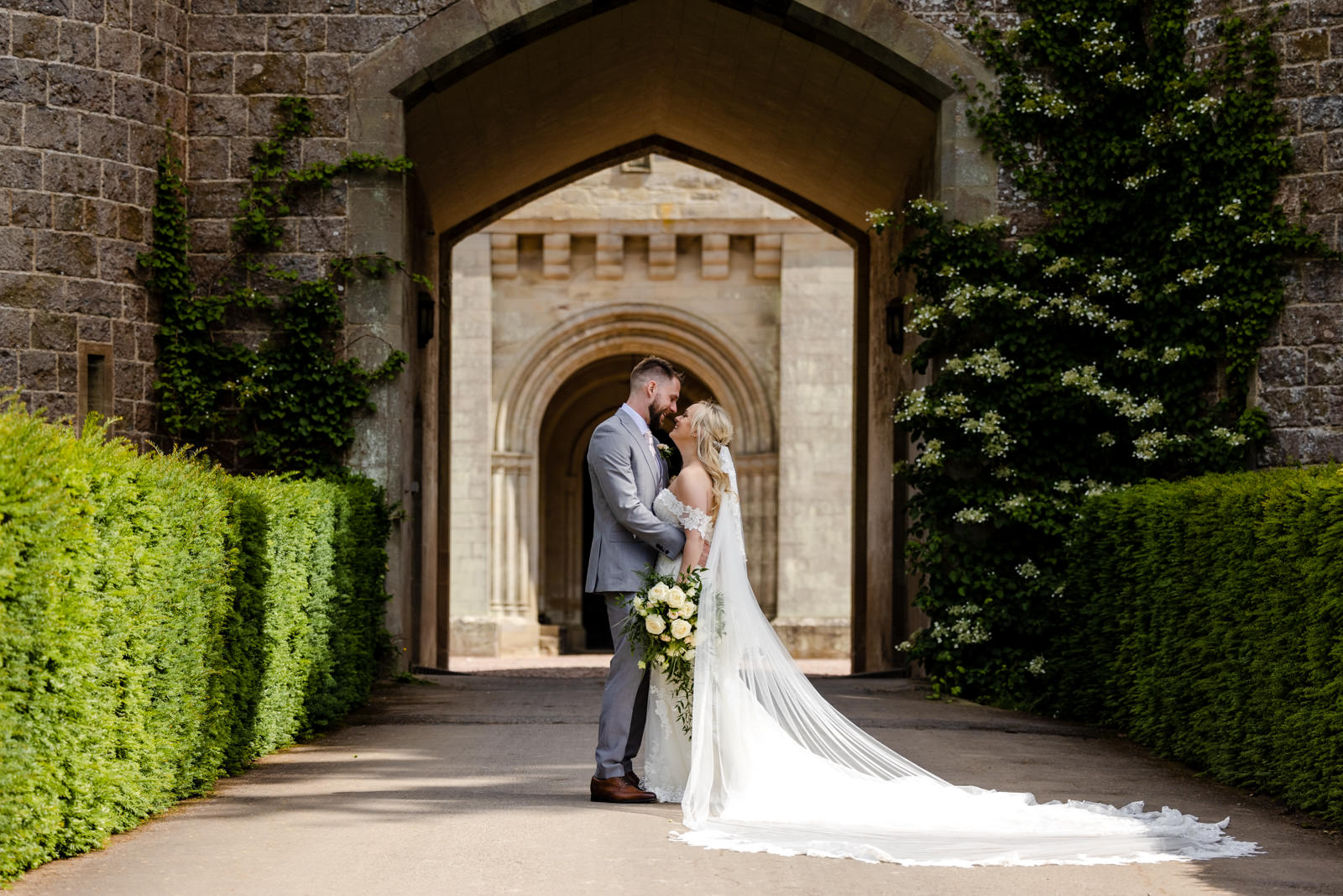 Eastnor Castle Wedding Photographer - Bride and Groom by gate